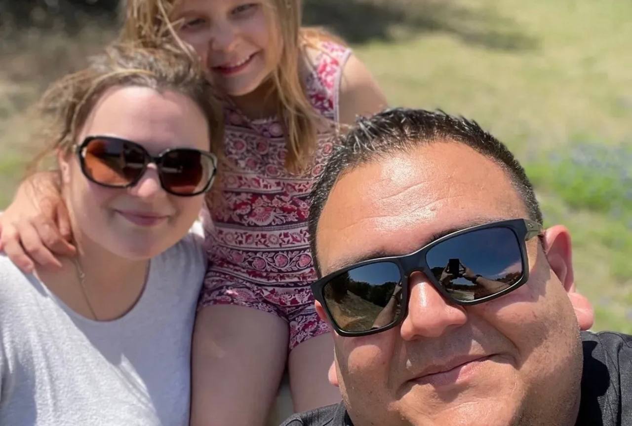 The family behind K Creating Crafts — husband wife and daughter outdoors in Bastrop Texas bluebonnets